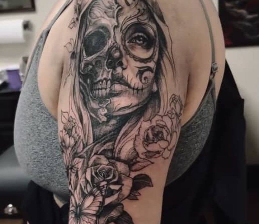 half skull half face tattoo